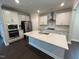 Modern kitchen with white cabinets, stainless steel appliances, and large center island at 5640 Cayden Cove Dr, Wendell, NC 27591