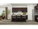 Modern kitchen featuring dark cabinets, stainless steel appliances, a spacious island with bar seating, and stylish pendant lights at 5640 Cayden Cove Dr, Wendell, NC 27591