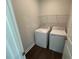 Compact laundry room with a washer, dryer, and wire shelving for storage at 5640 Cayden Cove Dr, Wendell, NC 27591