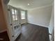 Versatile home office space with wood floors, ample natural light, and elegant trim at 5640 Cayden Cove Dr, Wendell, NC 27591