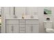Bright bathroom featuring double sinks, shaker cabinets, vanity, and modern fixtures at 5645 Cayden Cove Dr, Wendell, NC 27591