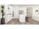 Bright, modern kitchen with white cabinets, stainless steel appliances, and a central island, perfect for cooking at 5645 Cayden Cove Dr, Wendell, NC 27591