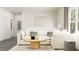 Living room with a comfortable sectional sofa, modern lighting, and neutral colors at 5645 Cayden Cove Dr, Wendell, NC 27591