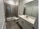 Bathroom featuring a glass shower, white vanity and sink with a light gray tiled floor at 5648 Cayden Cove Dr, Wendell, NC 27591