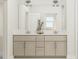 Bright bathroom featuring a double vanity with modern fixtures, white countertops, and ample storage, enhancing functionality and style at 5648 Cayden Cove Dr, Wendell, NC 27591