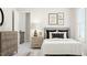 Bright bedroom featuring neutral decor, decorative pillows, and a quaint wooden bedside table, creating a serene and stylish space at 5648 Cayden Cove Dr, Wendell, NC 27591