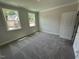 Bright, carpeted bedroom with natural light and two large windows with view of adjacent home at 5648 Cayden Cove Dr, Wendell, NC 27591