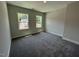 Bedroom featuring wall to wall carpeting, neutral paint, and two bright double hung windows at 5648 Cayden Cove Dr, Wendell, NC 27591
