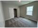 Bedroom featuring wall to wall carpeting, a window, and a closet with double doors at 5648 Cayden Cove Dr, Wendell, NC 27591