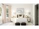 Bright bedroom with large window, stylish neutral decor, comfortable bed, and unique bedside tables providing a calming retreat at 5648 Cayden Cove Dr, Wendell, NC 27591