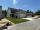 New construction features a two-story home with an attached and detached garage, and a fresh lawn at 5648 Cayden Cove Dr, Wendell, NC 27591
