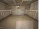 Spacious two-car garage with a newly sealed concrete floor, ample lighting, and insulated garage door at 5648 Cayden Cove Dr, Wendell, NC 27591