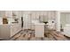 Bright kitchen featuring a large island with seating and modern stainless-steel appliances at 5648 Cayden Cove Dr, Wendell, NC 27591