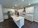 Modern kitchen with stainless appliances, quartz counters, tile backsplash, and white cabinetry at 5648 Cayden Cove Dr, Wendell, NC 27591