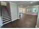 Spacious living room with hardwood floors, stairs and lots of natural light from bright windows at 5648 Cayden Cove Dr, Wendell, NC 27591