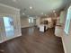 Open concept living room and kitchen with hardwood floors and view of rear patio through glass doors at 5648 Cayden Cove Dr, Wendell, NC 27591