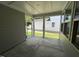 View of the screened porch with gray concrete floor, looking out to the backyard at 5648 Cayden Cove Dr, Wendell, NC 27591