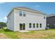 Rear view of house with sliding glass door to patio and horizontal windows at 571 White Birch Ln, Angier, NC 27501