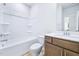 Bright, white bathroom featuring a shower-tub combo and wooden vanity with storage at 571 White Birch Ln, Angier, NC 27501