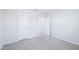 A secondary bedroom features neutral walls, carpet, and two doors with white trim at 571 White Birch Ln, Angier, NC 27501