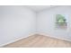 Bright, clean bedroom features a window and light wood-look flooring at 571 White Birch Ln, Angier, NC 27501