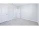 A secondary bedroom features neutral walls, carpet, and two doors with white trim at 571 White Birch Ln, Angier, NC 27501