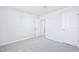 Bright bedroom features neutral carpet, white walls and ceiling, and two doors at 571 White Birch Ln, Angier, NC 27501
