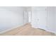 Clean and simple bedroom features light wood-look floors and white doors at 571 White Birch Ln, Angier, NC 27501