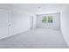 Bright bedroom with carpet, white walls, and two windows at 571 White Birch Ln, Angier, NC 27501