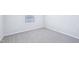 A secondary bedroom features neutral walls, carpet, baseboards, and a sunny window at 571 White Birch Ln, Angier, NC 27501