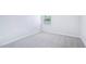 A secondary bedroom features neutral walls, carpet, baseboards, and a sunny window at 571 White Birch Ln, Angier, NC 27501