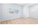 Bright bedroom with laminate floors, white walls, and a door with a view at 571 White Birch Ln, Angier, NC 27501