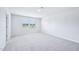 Neutral bedroom with carpet, white walls, and two windows at 571 White Birch Ln, Angier, NC 27501