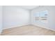 Bright bedroom with laminate floors, white walls, and a window at 571 White Birch Ln, Angier, NC 27501