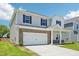 A two-story home boasts a brick and vinyl exterior and an attached two car garage at 571 White Birch Ln, Angier, NC 27501
