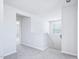 Upstairs hallway features gray carpet, white walls, and a window with natural light at 571 White Birch Ln, Angier, NC 27501