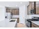 This kitchen features quartz countertops, stainless steel appliances and modern lighting at 571 White Birch Ln, Angier, NC 27501