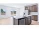 Bright kitchen features an island with stainless steel appliances and outdoor views at 571 White Birch Ln, Angier, NC 27501