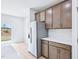 Bright kitchen features stainless steel refrigerator and a sliding door to the backyard at 571 White Birch Ln, Angier, NC 27501