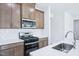 Well-lit kitchen features stainless steel appliances and light countertops at 571 White Birch Ln, Angier, NC 27501