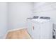 Well-lit laundry room featuring a modern washer and dryer at 571 White Birch Ln, Angier, NC 27501