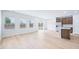 Open-concept living area with light hardwood floors connecting to kitchen and dining at 571 White Birch Ln, Angier, NC 27501