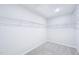 Spacious walk-in closet featuring white wire shelving for optimal storage and organization solutions at 571 White Birch Ln, Angier, NC 27501