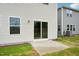 The backyard features a concrete patio and sliding glass doors leading into the home, providing outdoor living space at 591 White Birch Ln, Angier, NC 27501