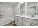 Bright bathroom features a double vanity, bathtub, and commode at 591 White Birch Ln, Angier, NC 27501