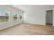 Well-lit bedroom with hardwood floors, large windows, and neutral walls at 591 White Birch Ln, Angier, NC 27501