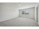 Neutral carpeted bedroom with freshly painted walls features a light-filled window at 591 White Birch Ln, Angier, NC 27501