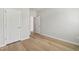Neutral bedroom with hardwood floors, white walls, and two white doors at 591 White Birch Ln, Angier, NC 27501