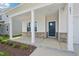 A charming covered front porch of a home with brick accents and white pillars at 591 White Birch Ln, Angier, NC 27501