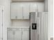 Side-by-side stainless steel refrigerator and white cabinets in kitchen at 591 White Birch Ln, Angier, NC 27501